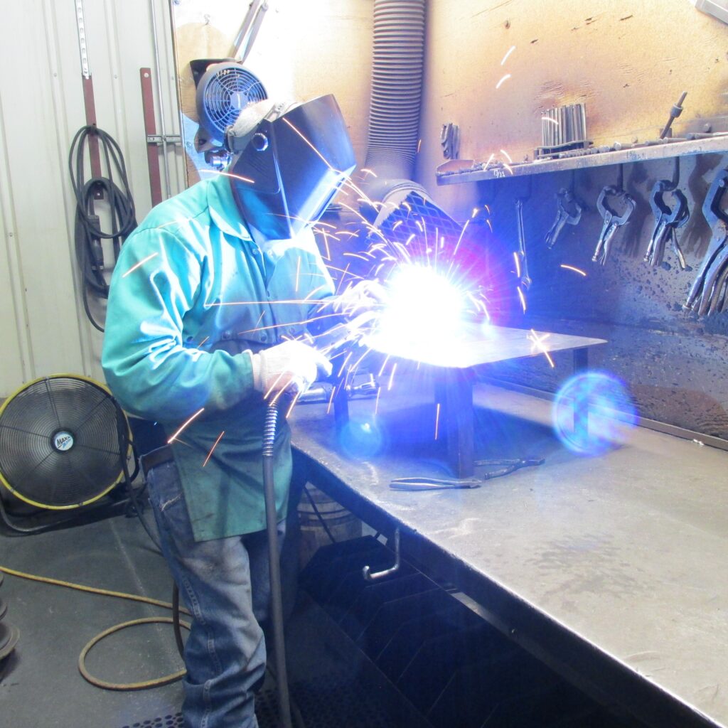 CW Mill employee welding mounting kit.